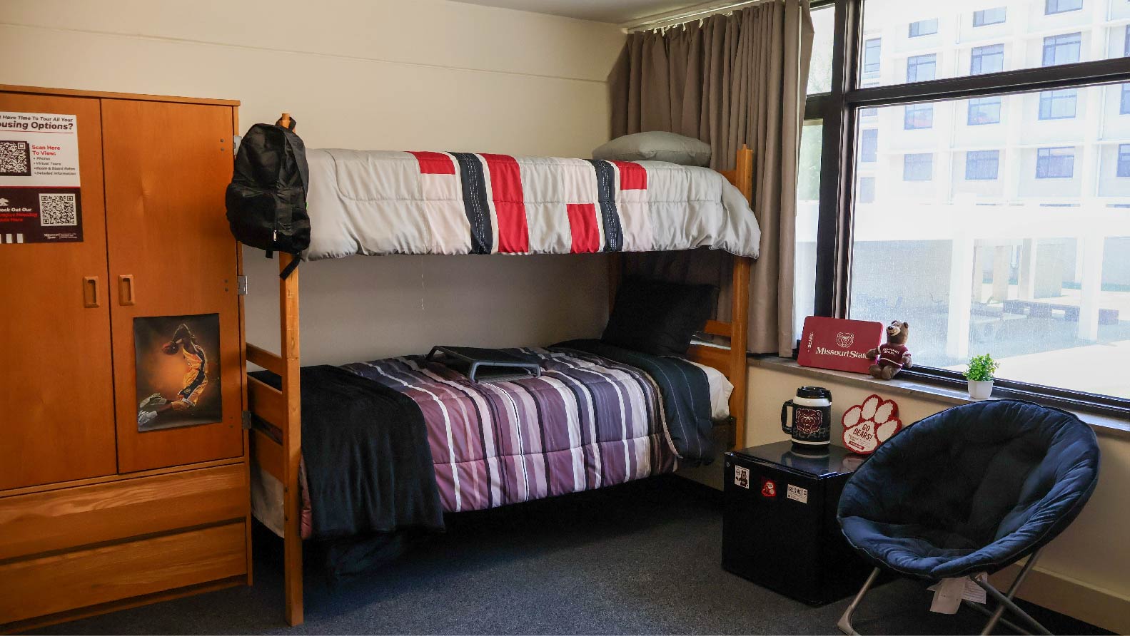 bedroom with bunked beds wardrobe and small fridge